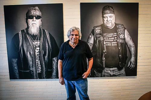 Moses Olmos poses in front of his work.